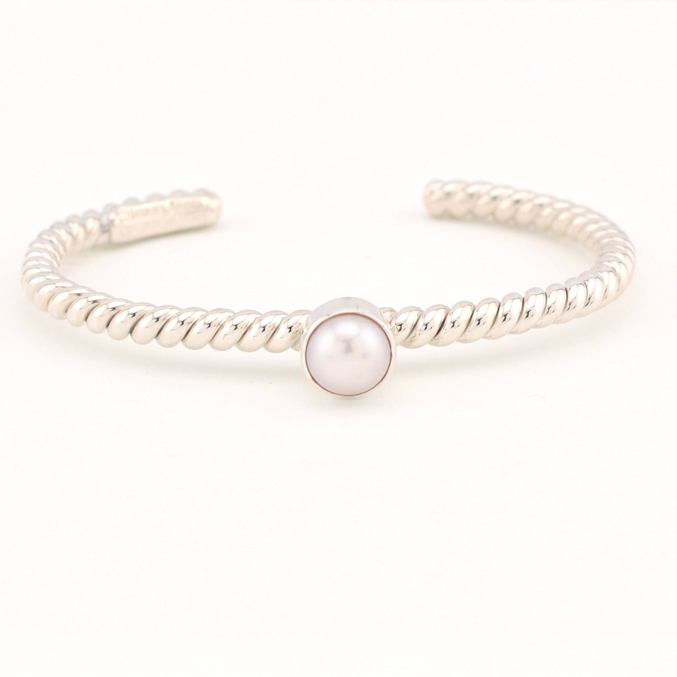 Silver bracelet with a pearl on a white background
