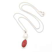 Necklace with a red stone pendant on a white background