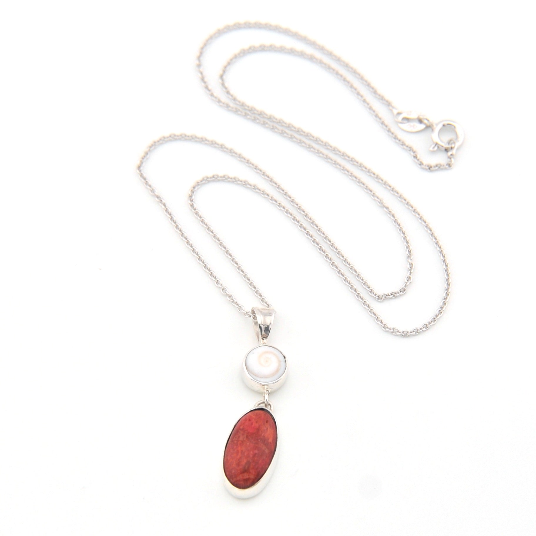 Necklace with a red stone pendant on a white background
