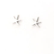 Pair of star-shaped earrings on a white background
