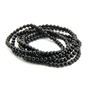 Black beaded necklace on a white background