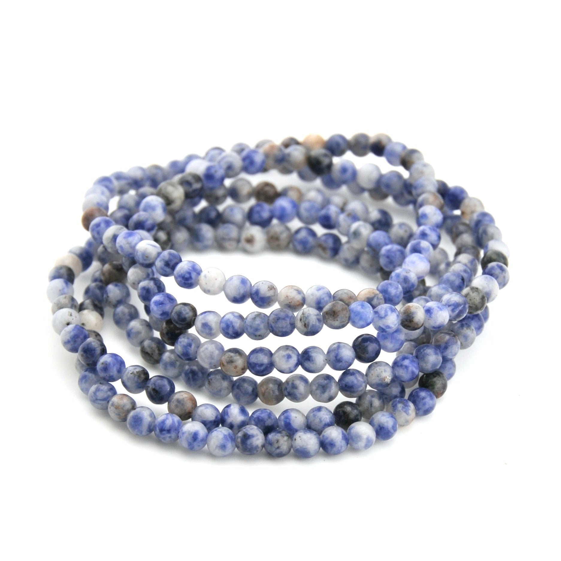 Stack of blue and gray beaded bracelets on a white background