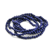 String of blue beads on a white background