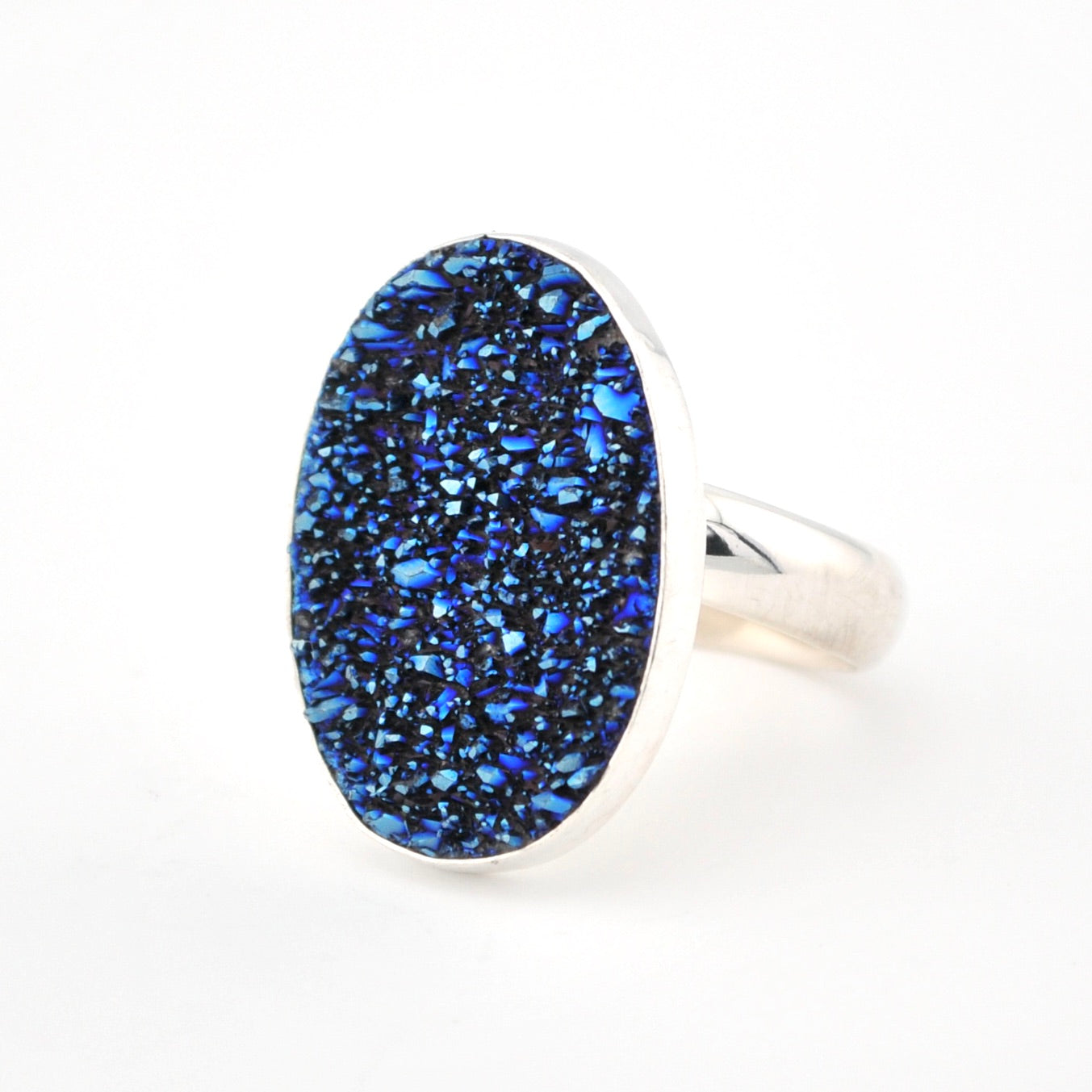 Ring with blue speckled stone on a white background