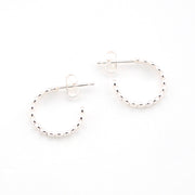 Silver hoop earrings on a white background