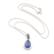 Necklace with a blue kyanite teardrop pendant on a white background