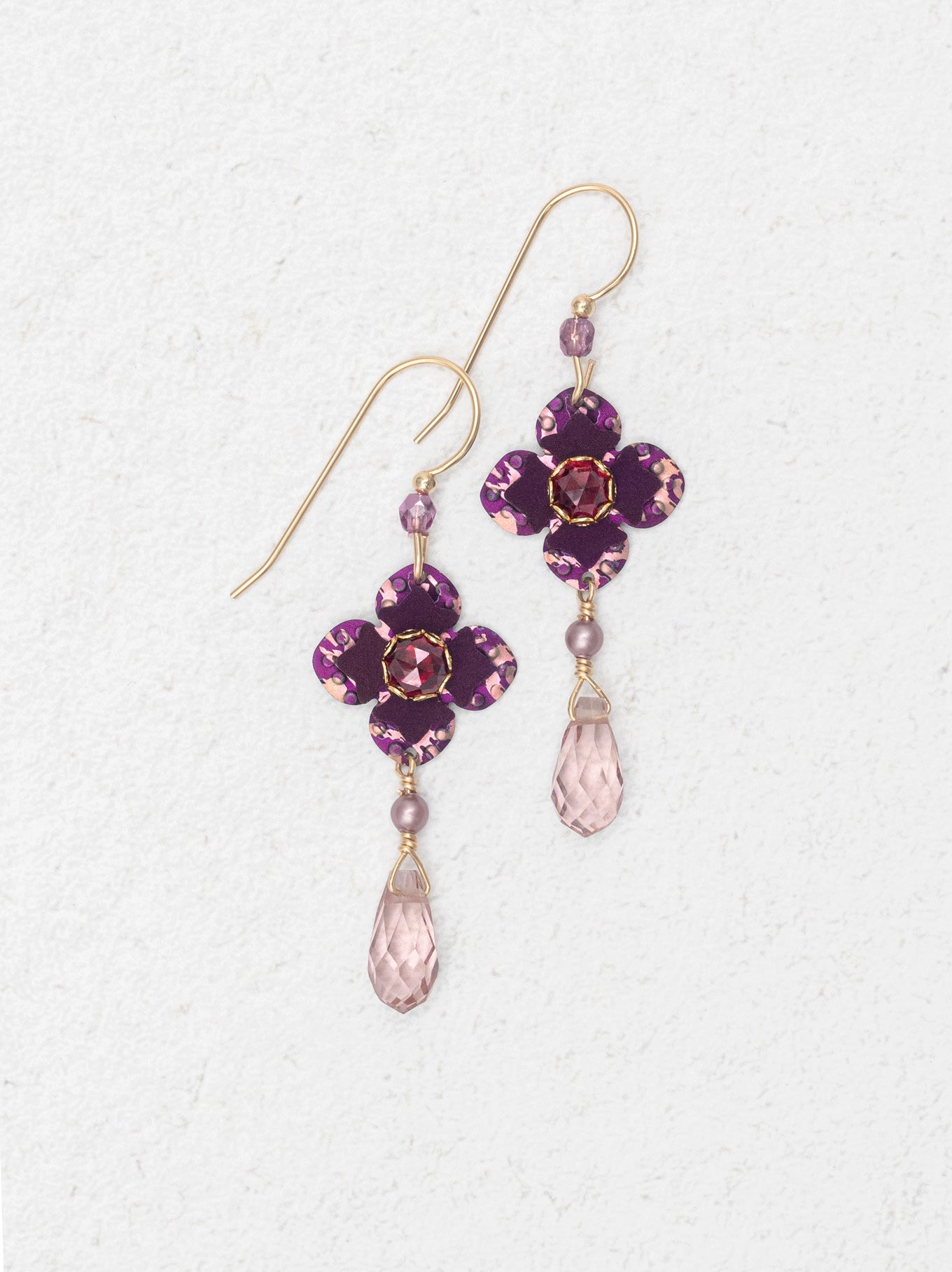 Purple flower-shaped earrings with pink teardrop beads on a white background