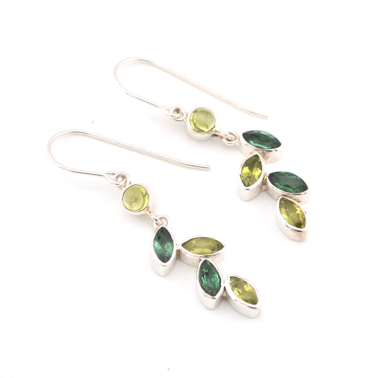 Pair of silver earrings with green gemstones on a white background