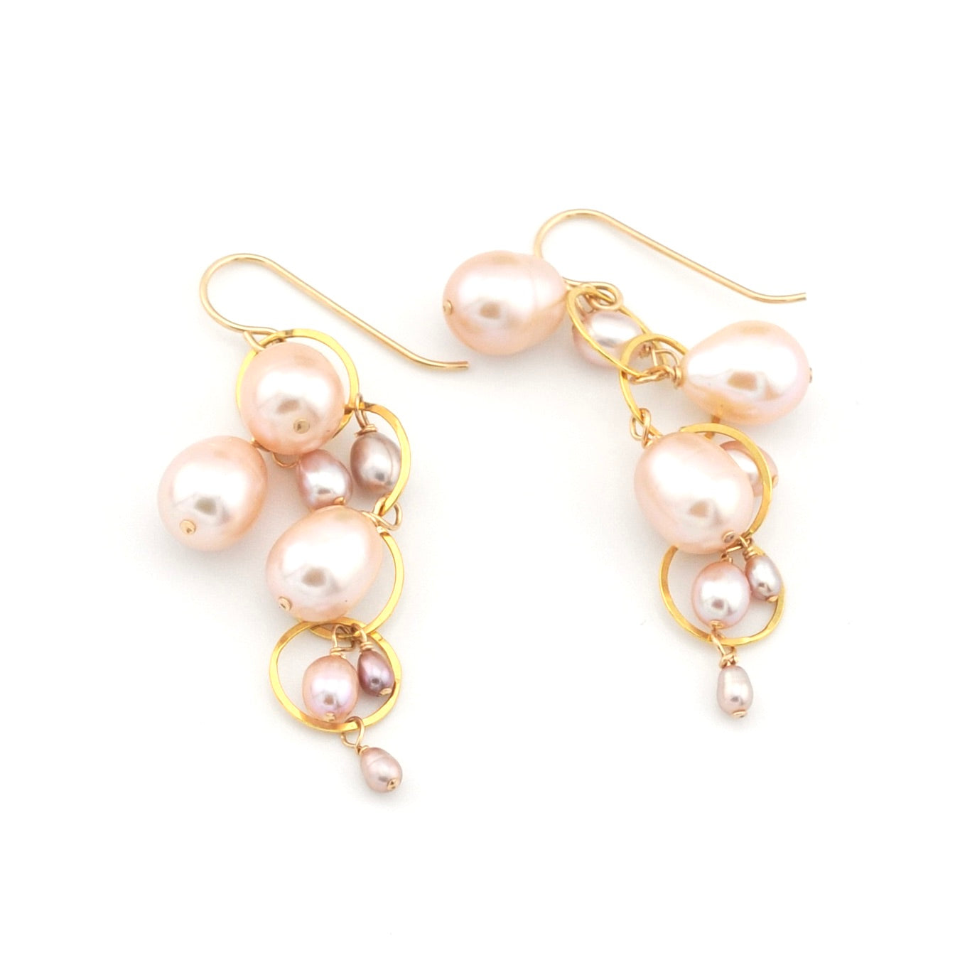Pearl earrings with gold hooks on a white background