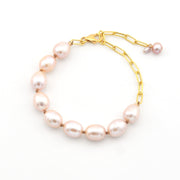 Pearl bracelet with gold chain on a white background