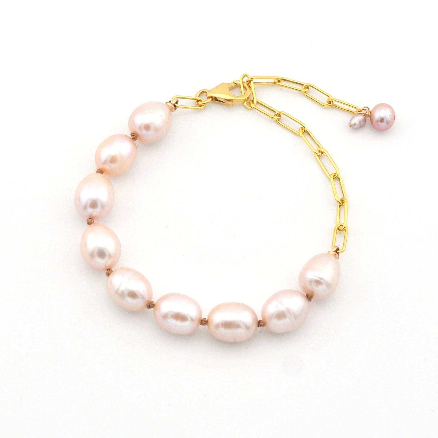 Pearl bracelet with gold chain on a white background