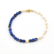 Bracelet with blue beads and gold accents on a white background