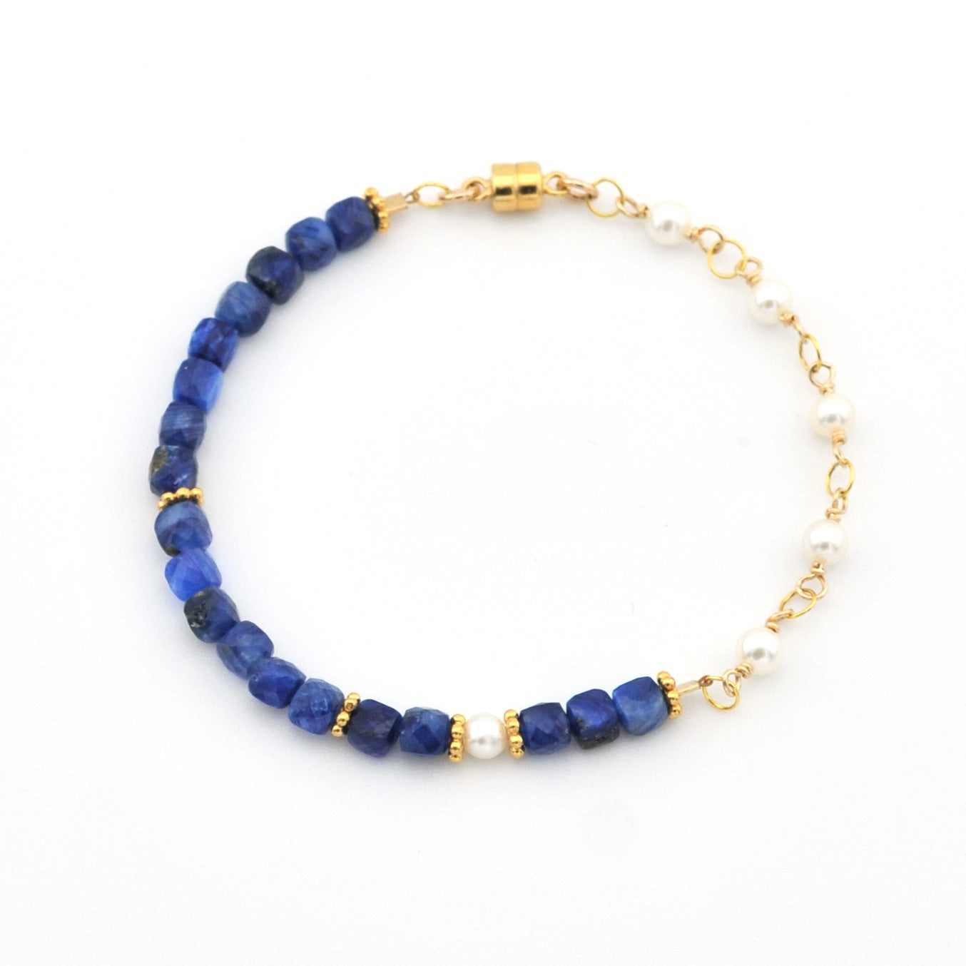 Bracelet with blue beads and gold accents on a white background