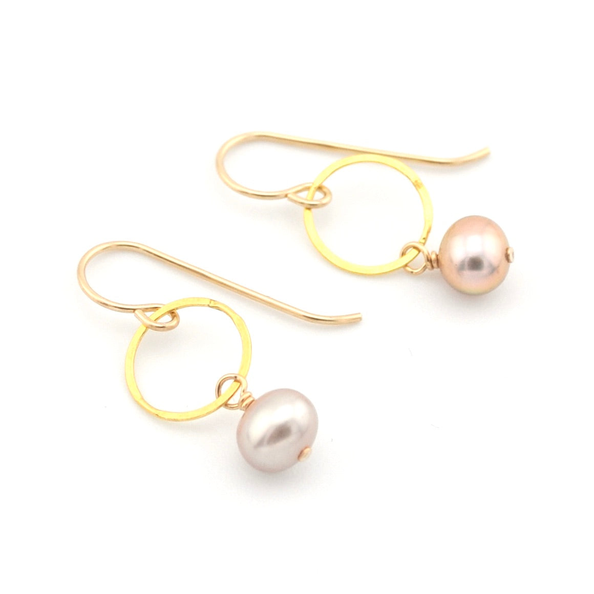 Pair of gold earrings with pearls on a white background