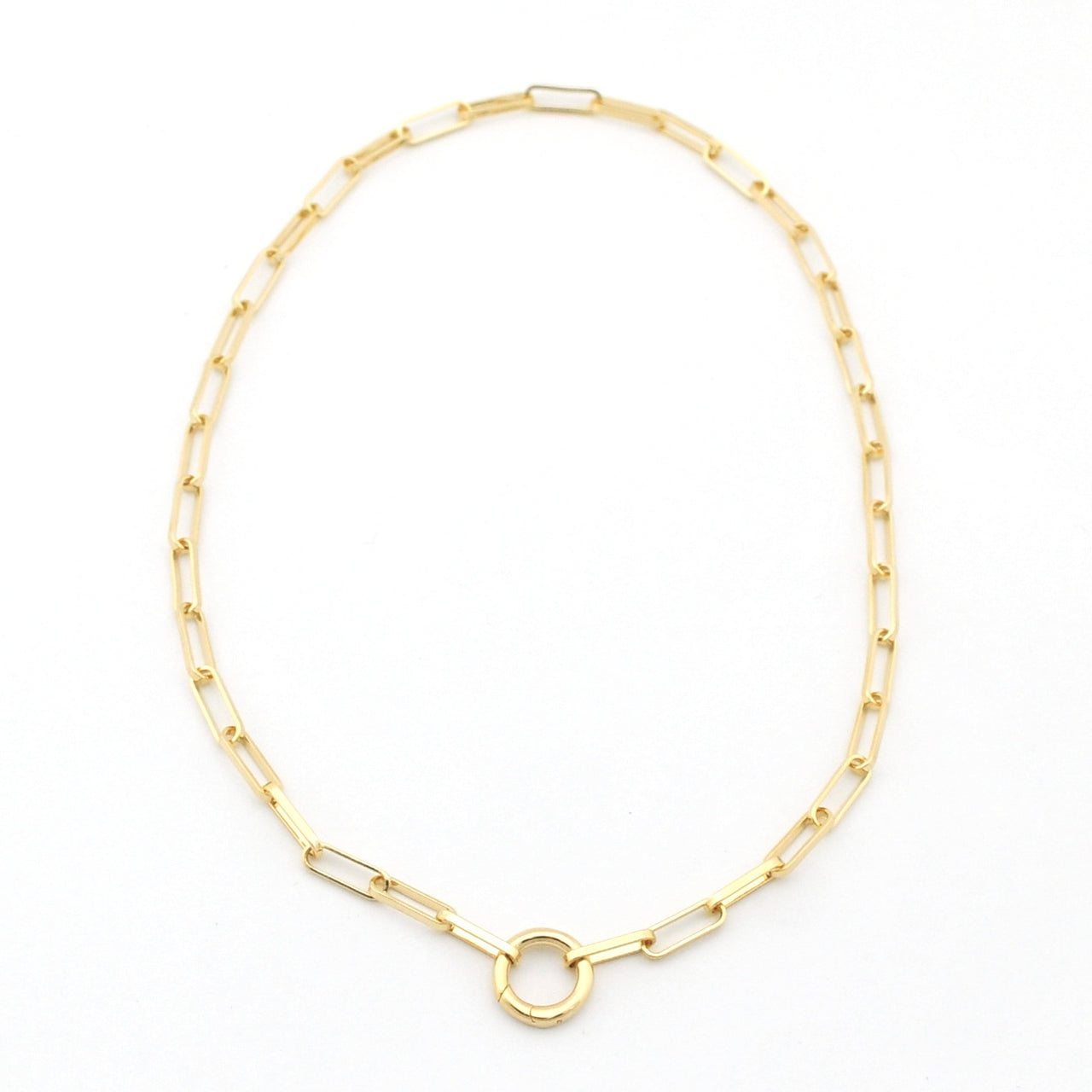 Gold chain necklace with a central circular pendant on a white background