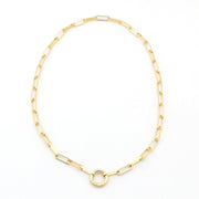 Gold chain necklace with a central circular pendant on a white background