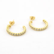 Gold hoop earrings with embedded stones on a white background