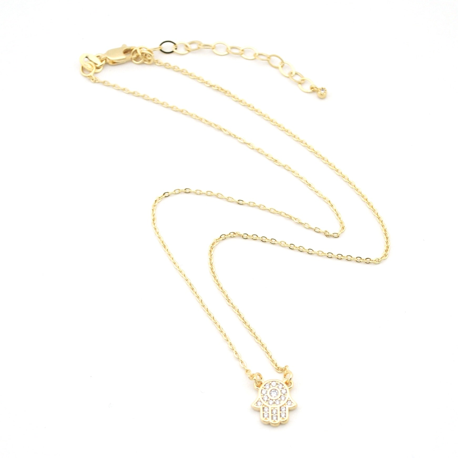 Gold necklace with a small pendant on a white background