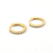Gold hoop earrings with embedded stones on a white background