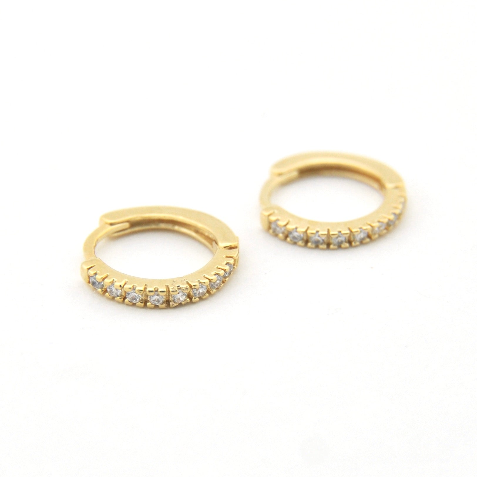 Gold hoop earrings with embedded stones on a white background