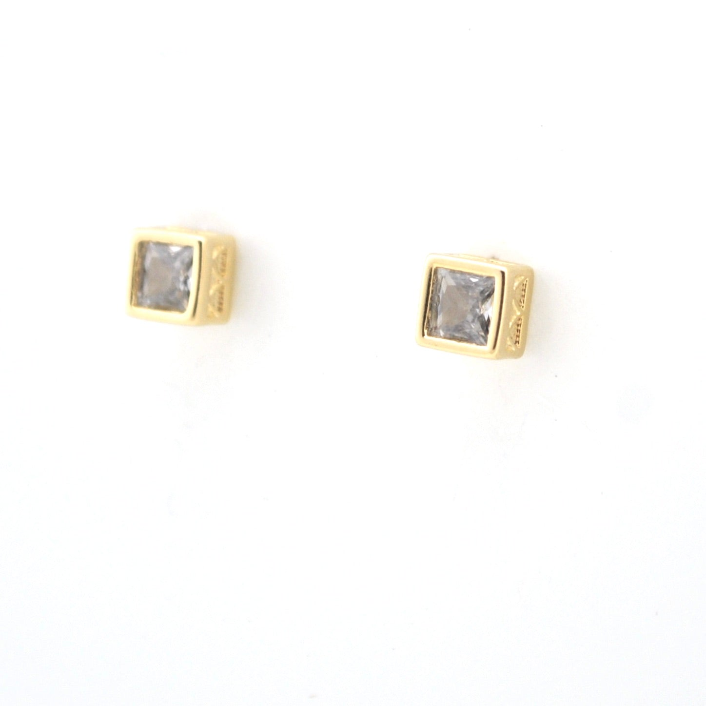 Gold square earrings with clear gemstones on a white background