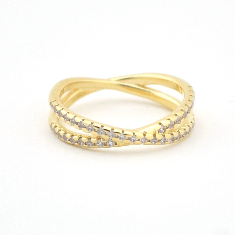 Gold ring with diamond accents on a white background