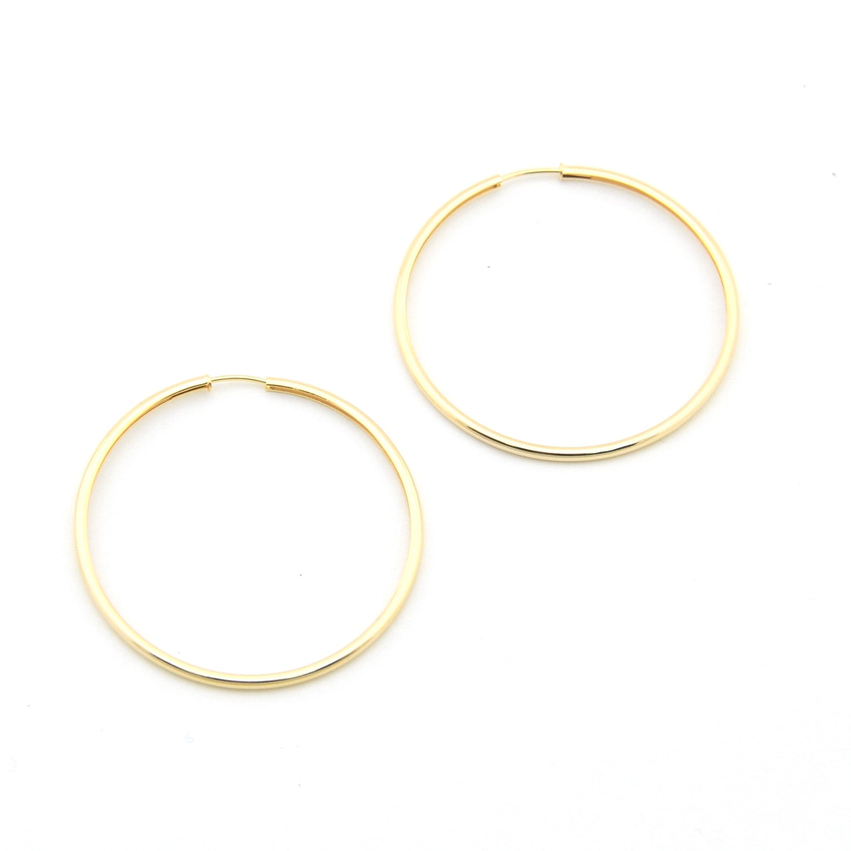 Gold hoop earrings on a white background