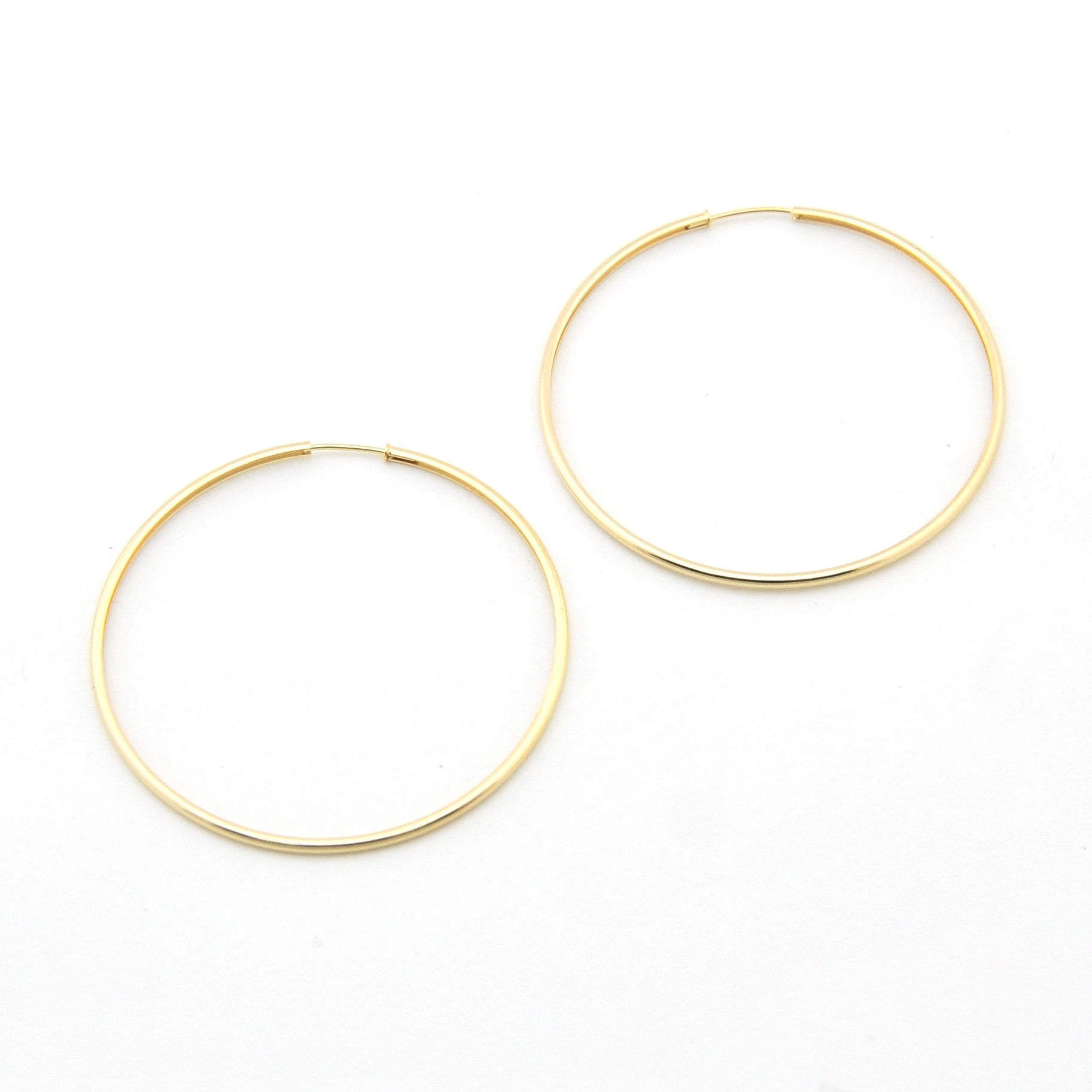 Gold hoop earrings on a white background