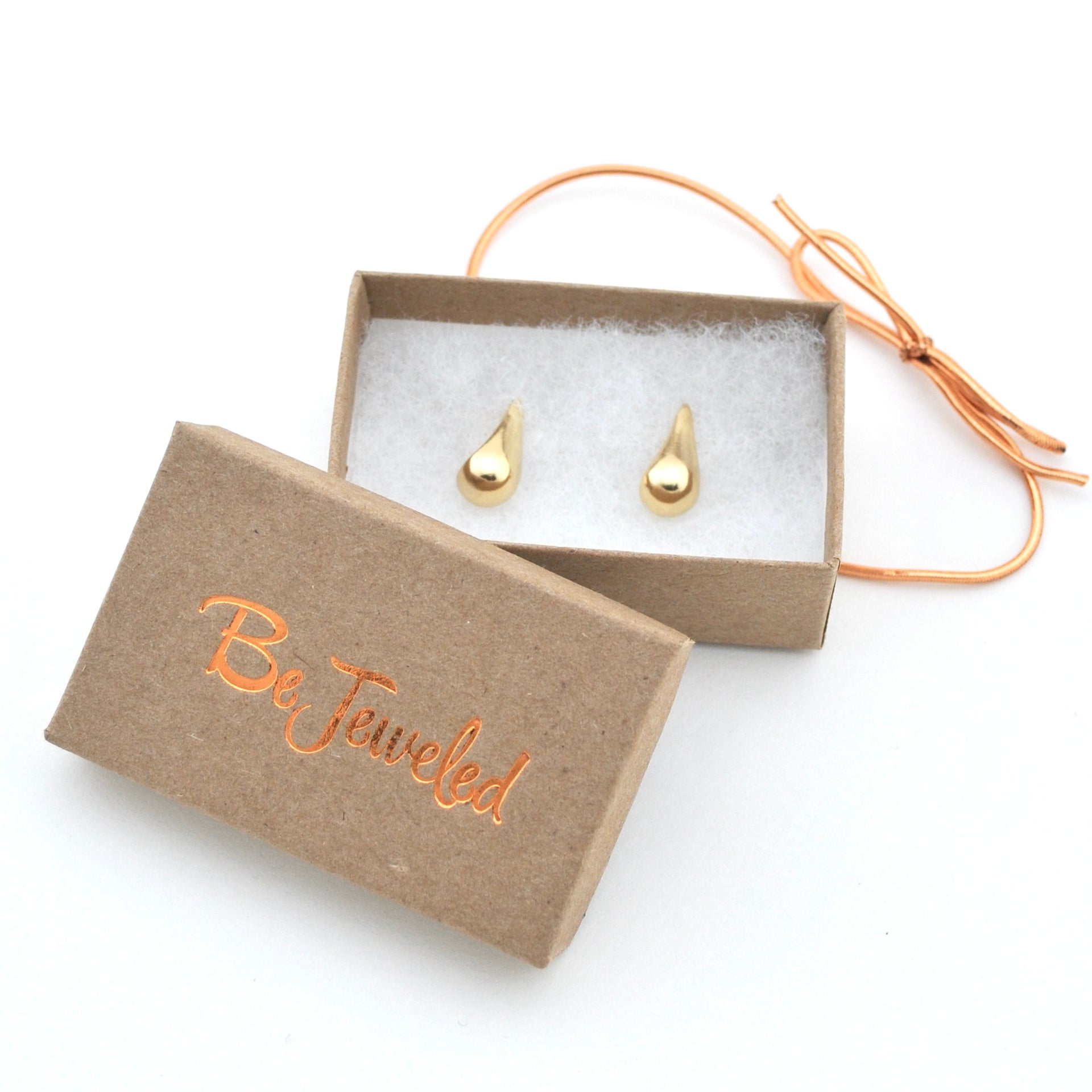 Gold teardrop earrings in a 'Be Jeweled' box on a white background