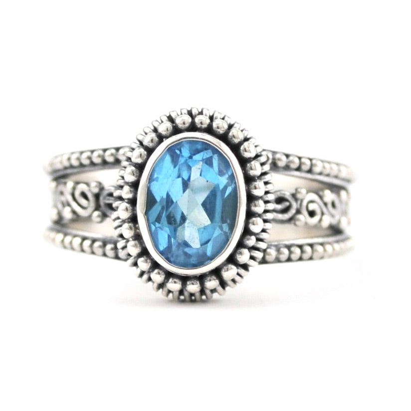 Front View Silver Blue Topaz 6x8mm Oval 3 Band Scroll Ring