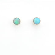 Pair of round opal stud earrings on a white background