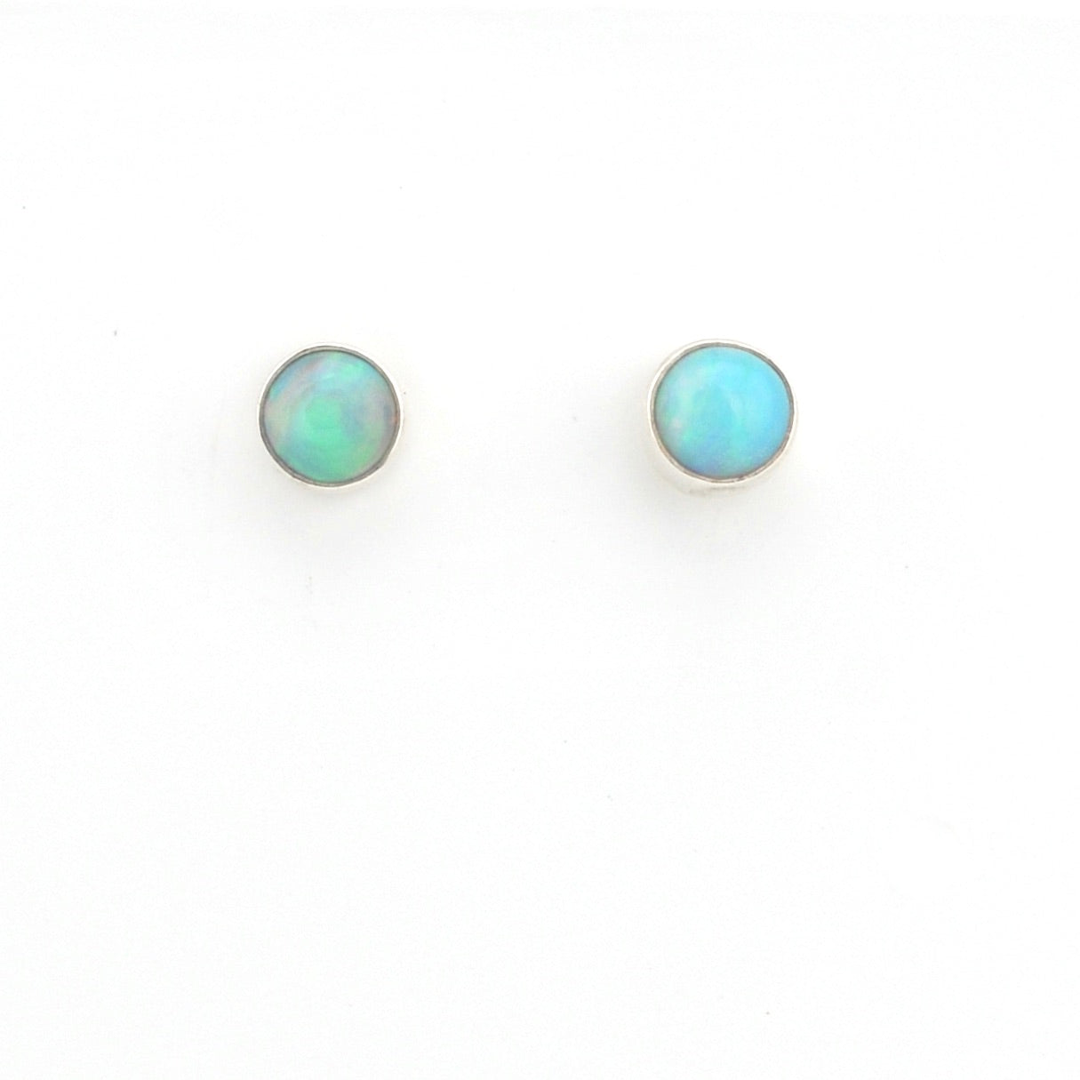 Pair of round opal stud earrings on a white background