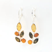 Pair of earrings with leaf-shaped amber stones on a white background