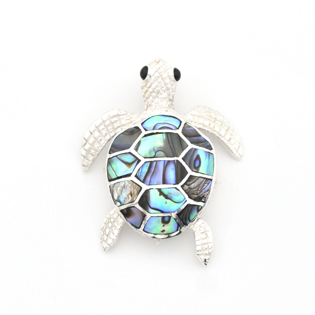 Tortoiseshell turtle brooch on a white background