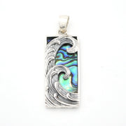 Pendant with wave design and abalone shell inlay on a white background