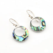 A pair of silver dangle earrings featuring circular openwork designs filled with iridescent abalone shell inlay, displayed on a clean white background.