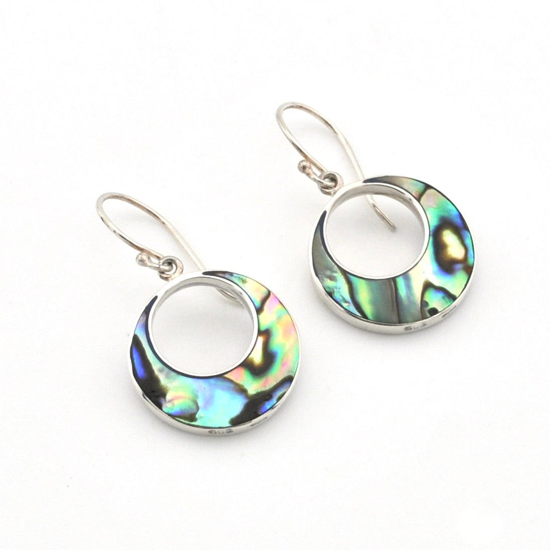 A pair of silver dangle earrings featuring circular openwork designs filled with iridescent abalone shell inlay, displayed on a clean white background.
