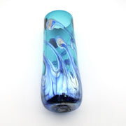 A hand-blown glass cylinder vase featuring a vibrant turquoise blue body with elegant, flowing swirls of lighter blue, white, and deep navy glass at the base, set against a plain white background.
