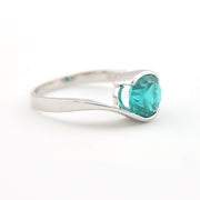 Silver ring with a teal gemstone on a white background