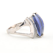 Silver ring with a blue gemstone on a white background