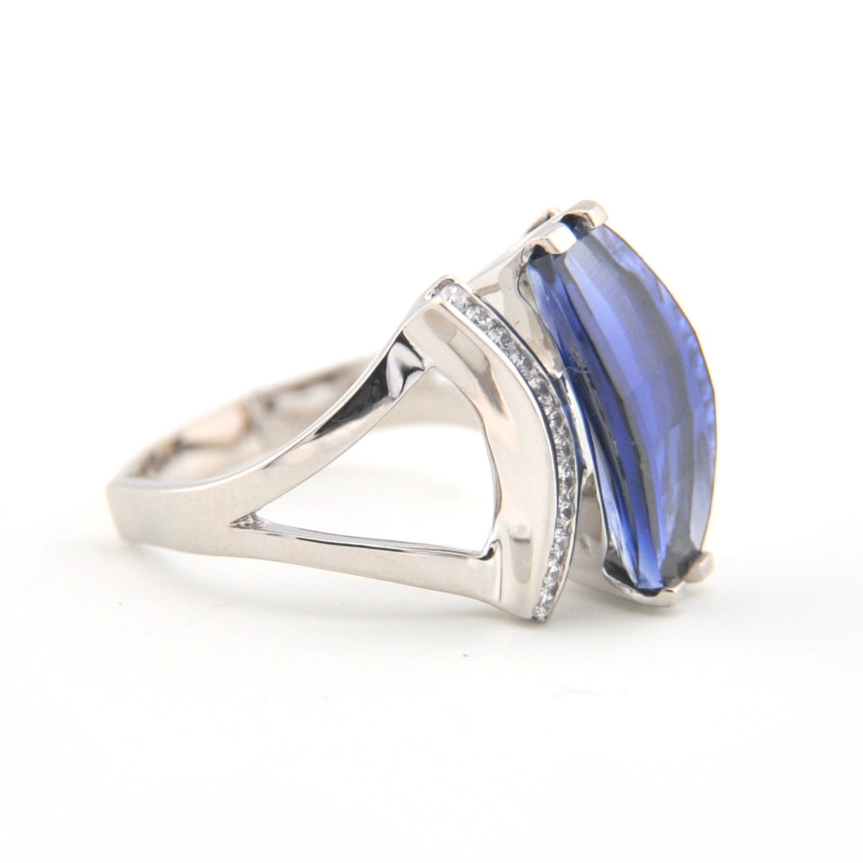 Silver ring with a blue gemstone on a white background