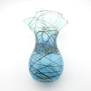 A light blue glass vase with a bulbous base and flared rim, decorated with black and brown organic web-like lines, shown on a plain white background.