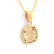 Gold pendant necklace on a white background