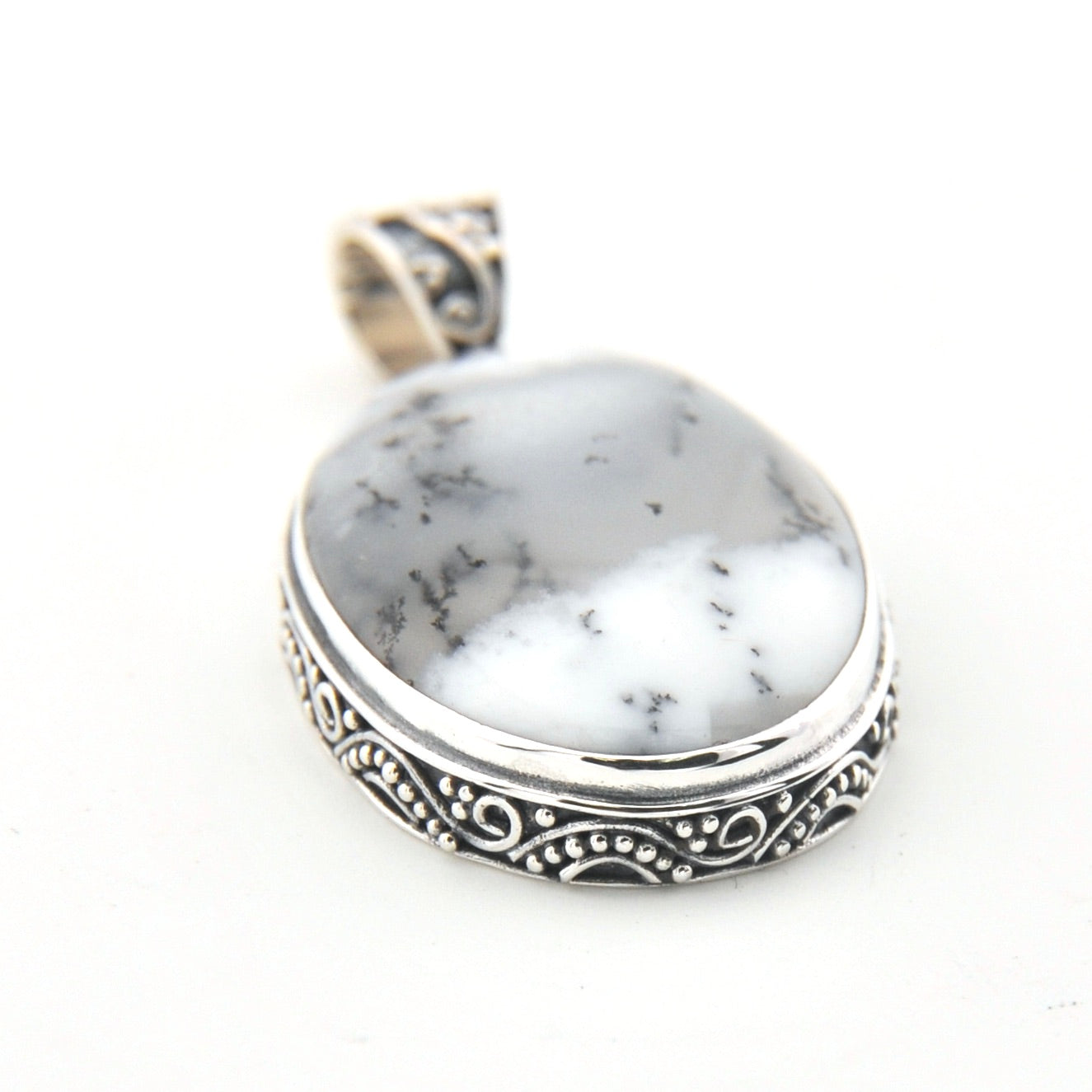 Pendant with white stone and silver border on a white background