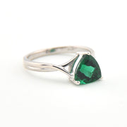 Silver ring with a green gemstone on a white background