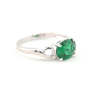 Silver ring with a green gemstone on a white background