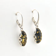 Pair of silver earrings with amber stones on a white background