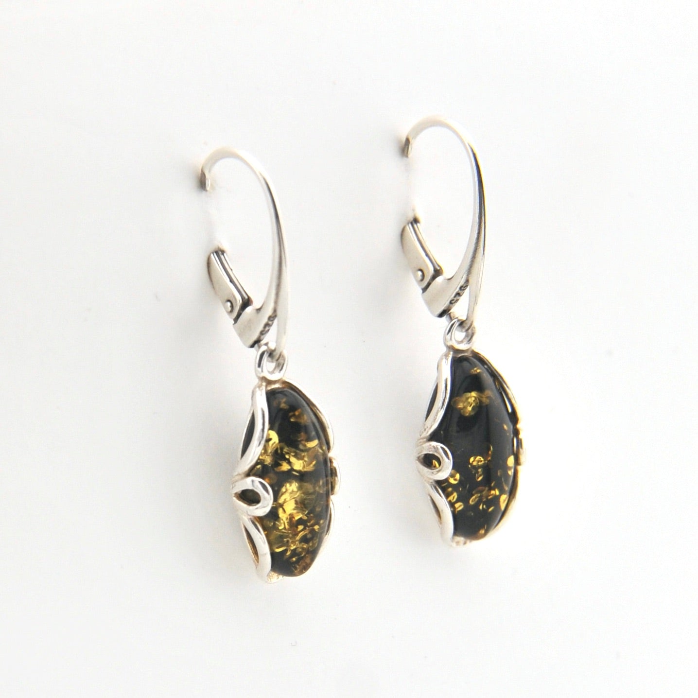Pair of silver earrings with amber stones on a white background