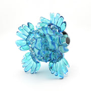 Glass fish figurine with blue and green swirl pattern on a white background