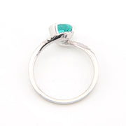 Silver ring with a green gemstone on a white background